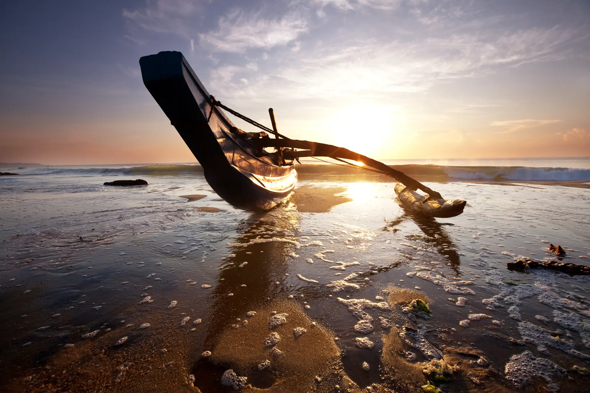 Outrigger boat at sunset